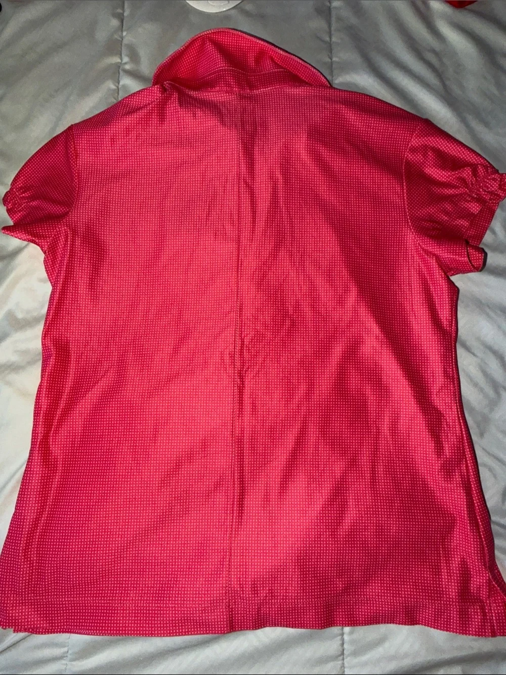 Pink/white polka-dotted Nike Golf Dri-FIT polo ship logo 